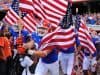 Florida Gators running on field during pre-game in The Swamp, carrying American flags 11-23-2013