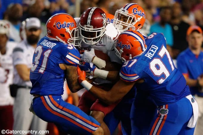 Sophomores Jalen Tabor and Quincy Wilson join redshirt freshman Justus Reed on a tackle in Florida's 61-13 win over New Mexico State- Florida Gators Football- 1280x852