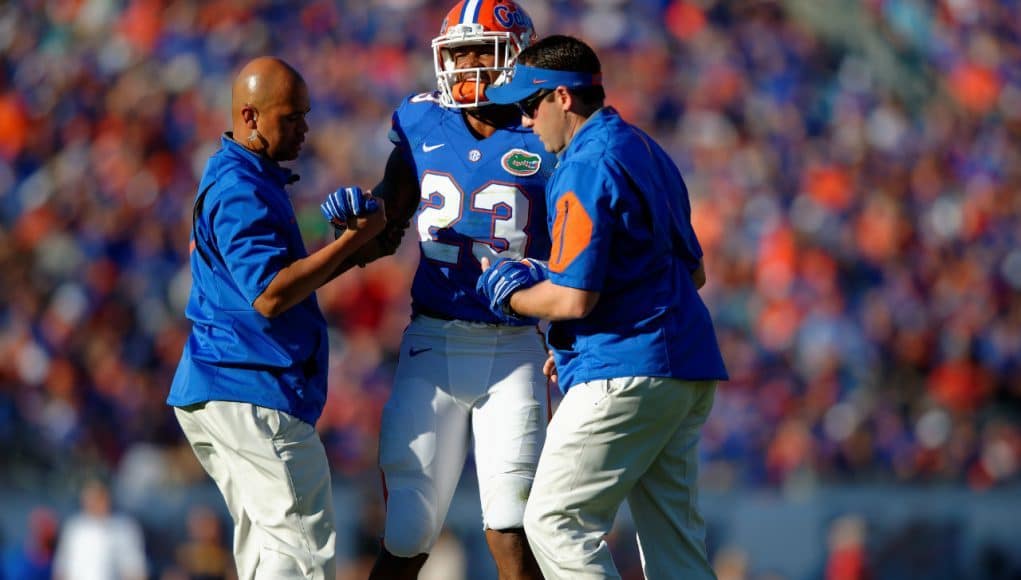 Florida Gators linebacker Jeremi Powell is helped off the field during the Florida Gators win over Georgia in 2015- Florida Gators football- 1280x852