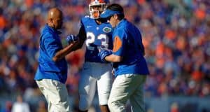 Florida Gators linebacker Jeremi Powell is helped off the field during the Florida Gators win over Georgia in 2015- Florida Gators football- 1280x852