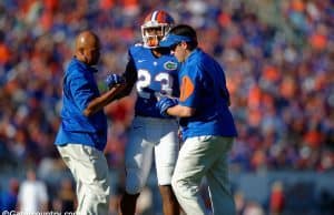 Florida Gators linebacker Jeremi Powell is helped off the field during the Florida Gators win over Georgia in 2015- Florida Gators football- 1280x852