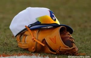 A Florida Gators baseball hat and glove in a win against Florida Gulf Coast University to start the season 2-0. February 20th, 2015- Florida Gators baseball- 1280x852