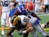 Florida Gators defensive lineman Keivonnis Davis tackles Michigan running back Drake Johnson during the 2016 Buffalo Wild Wings Citrus Bowl- Florida Gators football- 1280x855