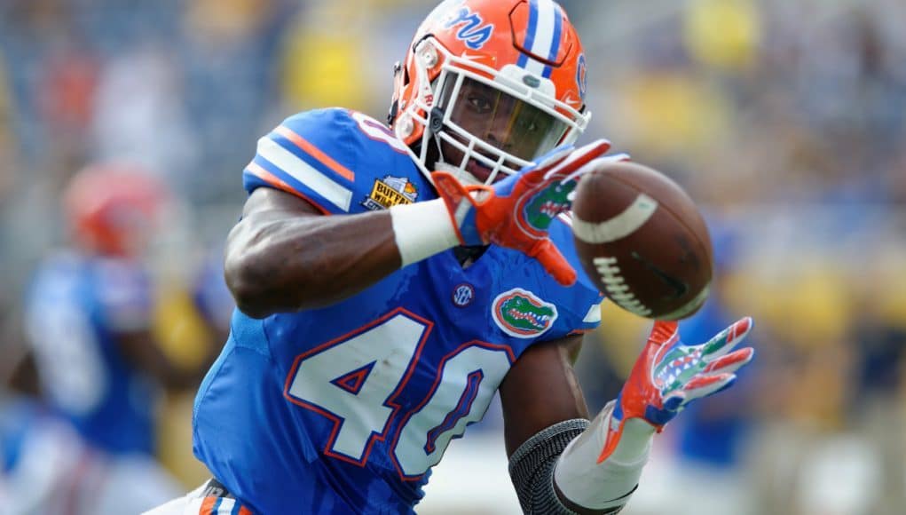 University of Florida linebacker Jarrad Davis catches a pass during warmups before the Buffalo Wild Wings Citrus Bowl vs. Michigan in 2016- Florida Gators football- 1280x852