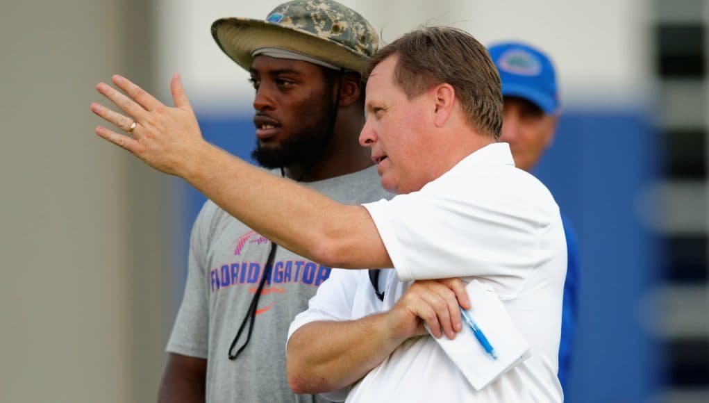 University of Florida head coach Jim McElwain and senior linebacker Jarrad Davis talk during McElwain’s youth football camp- Florida Gators football- 1280x852