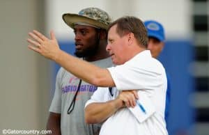 University of Florida head coach Jim McElwain and senior linebacker Jarrad Davis talk during McElwain’s youth football camp- Florida Gators football- 1280x852