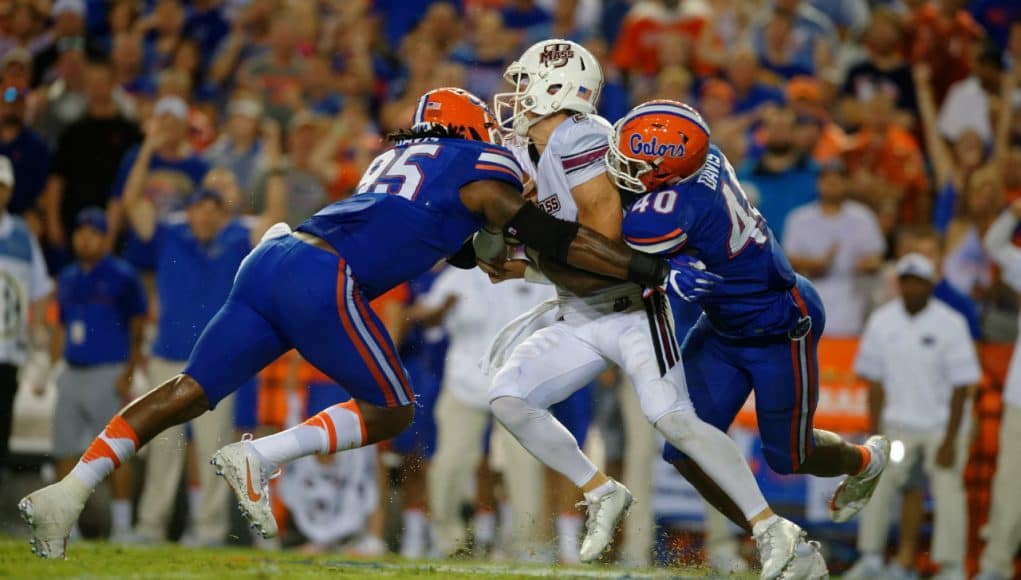 Jarrad Davis (40) and Keivonnis Davis (95) combine to sac UMass quarterback Ross Comis in the 2016 season opener- Florida Gators football- 1280x852