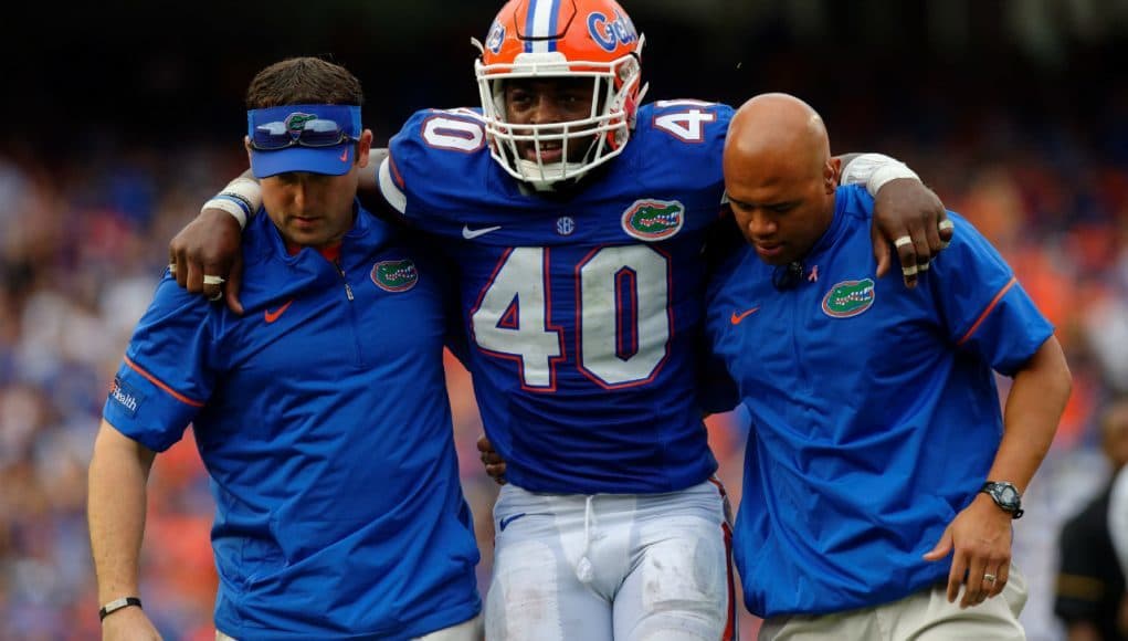 University of Florida linebacker Jarrad Davis is helped off of the field after sustaining an injury against Missouri- Florida Gators football-1280x852