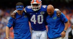 University of Florida linebacker Jarrad Davis is helped off of the field after sustaining an injury against Missouri- Florida Gators football-1280x852