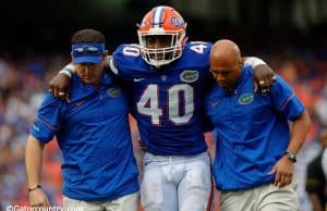 University of Florida linebacker Jarrad Davis is helped off of the field after sustaining an injury against Missouri- Florida Gators football-1280x852