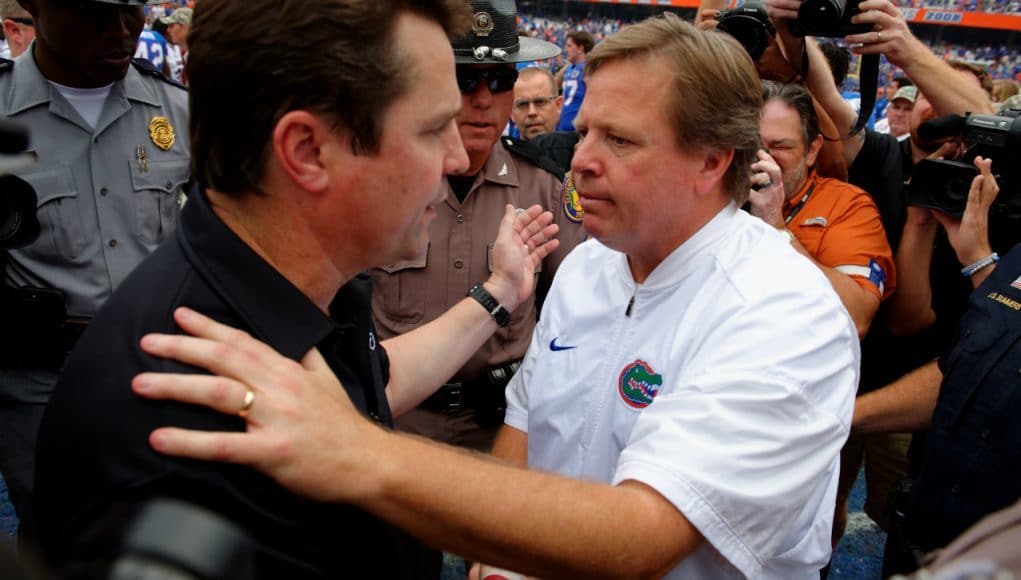 University of Florida head coach Jim McElwain meets Will Muschamp at midfield after the Gators beat the Gamecocks 20-7- Florida Gators football- 1280x852