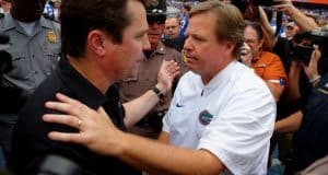 University of Florida head coach Jim McElwain meets Will Muschamp at midfield after the Gators beat the Gamecocks 20-7- Florida Gators football- 1280x852