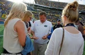 Florida Gators head coach Jim McElwain gives out gum to his daughters, a post game ritual for the family, after losing to the University of Michigan Wolverines - Florida Gators football- 1280x852