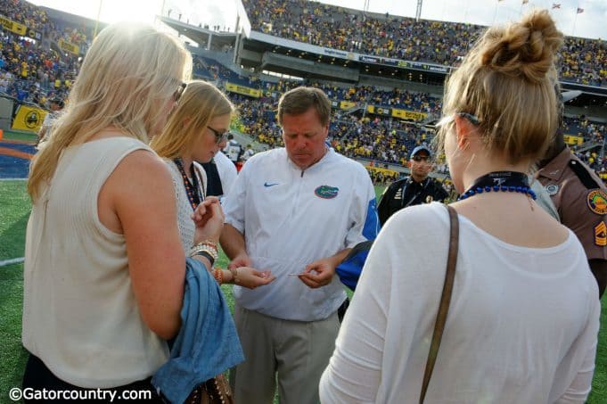 Florida Gators head coach Jim McElwain gives out gum to his daughters, a post game ritual for the family, after losing to the University of Michigan Wolverines - Florida Gators football- 1280x852
