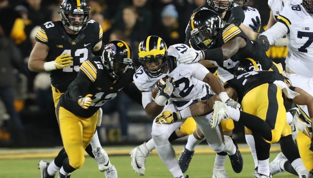 Nov 12, 2016; Iowa City, IA, USA; Michigan Wolverines running back Chris Evans (12) carries the ball as Iowa Hawkeyes defensive back Anthony Gair (12) and defensive back Desmond King (14) tackle during the first half at Kinnick Stadium. Mandatory Credit: Reese Strickland-USA TODAY Sports