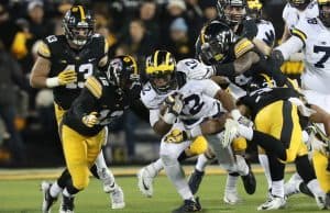 Nov 12, 2016; Iowa City, IA, USA; Michigan Wolverines running back Chris Evans (12) carries the ball as Iowa Hawkeyes defensive back Anthony Gair (12) and defensive back Desmond King (14) tackle during the first half at Kinnick Stadium. Mandatory Credit: Reese Strickland-USA TODAY Sports