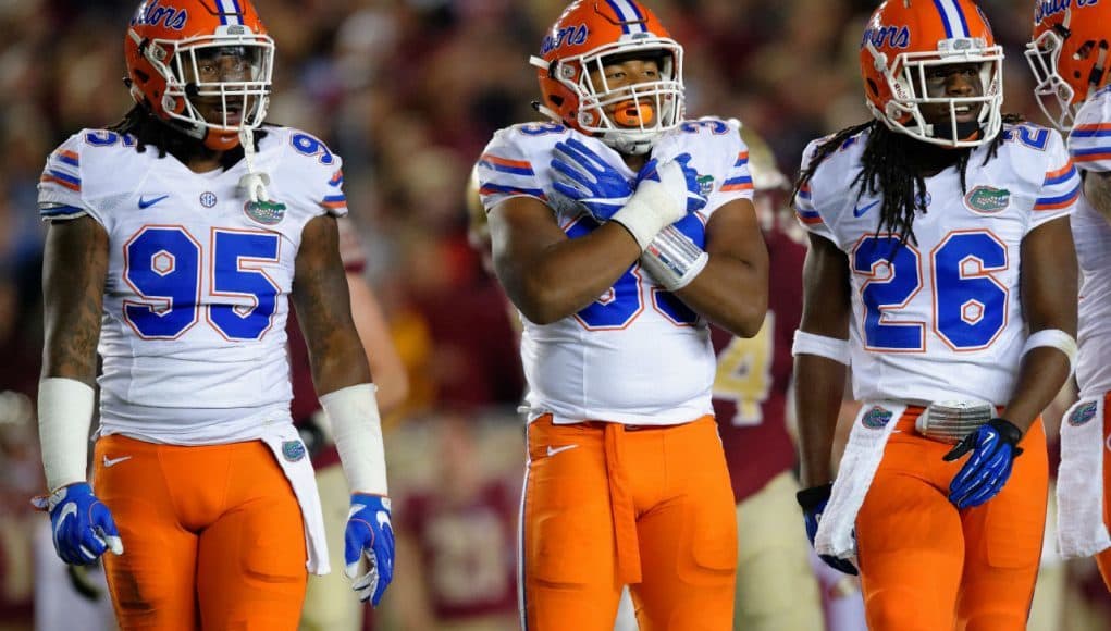 University of Florida defensive players Keivonnis Davis, David Reese and Marcell Harris on the field against Florida State- Florida Gators football- 1280x852