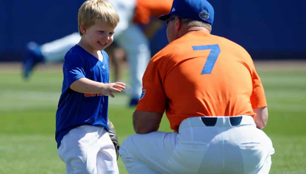 University of Florida head baseball coach Kevin O’Sullivan plays with his son Finn before the Gators final game against Miami- Florida Gators baseball- 1280x852