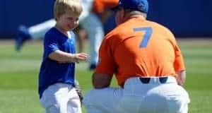 University of Florida head baseball coach Kevin O’Sullivan plays with his son Finn before the Gators final game against Miami- Florida Gators baseball- 1280x852