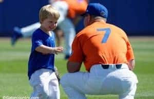 University of Florida head baseball coach Kevin O’Sullivan plays with his son Finn before the Gators final game against Miami- Florida Gators baseball- 1280x852