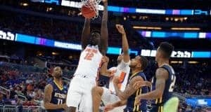 Florida Gators basketball player Gorjok Gak dunks against ETSU- 1280x853