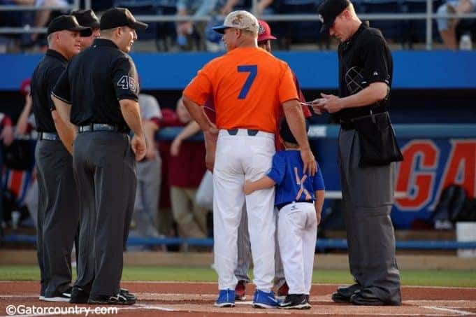 University of Florida head baseball coach Kevin O’Sullivan and his son Finn deliver the starting lineups to the umpire- Florida Gators baseball- 1280x852