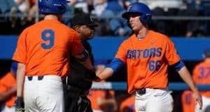 University of Florida outfielder Ryan Larson celebrates with Christian Hicks after scoring a run against Miami- Florida Gators baseball- 1280x852