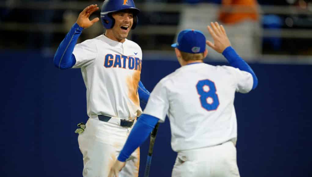 University of Florida infielders Jonathan India (6) and Deacon Liput (8) celebrate after India scored a run against Florida State- Florida Gators baseball- 1280x852