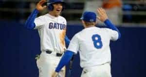 University of Florida infielders Jonathan India (6) and Deacon Liput (8) celebrate after India scored a run against Florida State- Florida Gators baseball- 1280x852