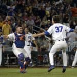 Florida Gators catcher Mike Rivera and pitcher Jackson Kowar celebrate the title- 1280x851