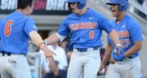 Jun 20, 2017; Omaha, NE, USA; Florida Gators infielder Deacon Liput (8) celebrates with infielder Jonathan India (6) and infielder Nelson Maldonado (27) after hitting a three run home run in the fourth inning against the Louisville Cardinals at TD Ameritrade Park Omaha. Mandatory Credit: Steven Branscombe-USA TODAY Sports