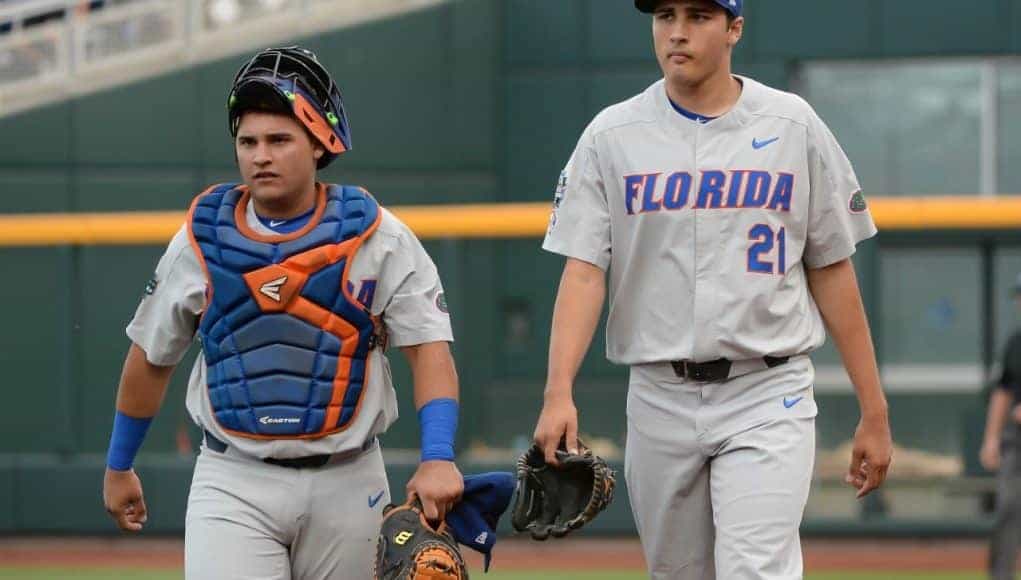 Jun 24, 2017; Omaha, NE, USA; Florida Gators pitcher Alex Faedo (21) and catcher Mike Rivera (4) walk to the dugout before the game against the TCU Horned Frogs at TD Ameritrade Park Omaha. Mandatory Credit: Steven Branscombe-USA TODAY Sports