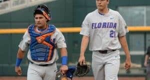 Jun 24, 2017; Omaha, NE, USA; Florida Gators pitcher Alex Faedo (21) and catcher Mike Rivera (4) walk to the dugout before the game against the TCU Horned Frogs at TD Ameritrade Park Omaha. Mandatory Credit: Steven Branscombe-USA TODAY Sports