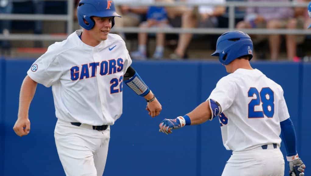 University of Florida catcher JJ Schwarz celebrates with Mark Kolozsvary after scoring a run against Kentucky- Florida Gators baseball- 1280x852