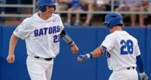 University of Florida catcher JJ Schwarz celebrates with Mark Kolozsvary after scoring a run against Kentucky- Florida Gators baseball- 1280x852