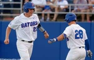 University of Florida catcher JJ Schwarz celebrates with Mark Kolozsvary after scoring a run against Kentucky- Florida Gators baseball- 1280x852