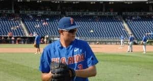 University of Florida pitcher Garrett Milchin warms up before the Florida Gators CWS game against the Louisville Cardinals- Florida Gators baseball- 1280x850