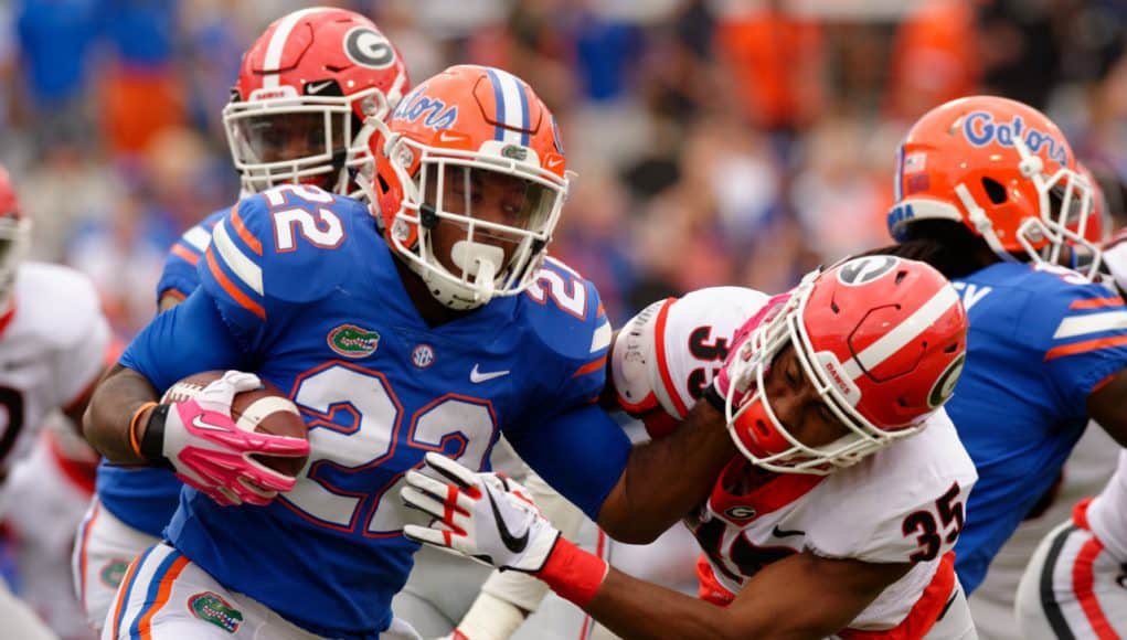 University of Florida running back Lamical Perine stiff arms a Georgia defender- Florida Gators football- 1280x852