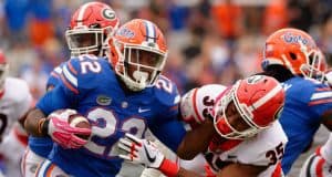 University of Florida running back Lamical Perine stiff arms a Georgia defender- Florida Gators football- 1280x852