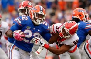 University of Florida running back Lamical Perine stiff arms a Georgia defender- Florida Gators football- 1280x852