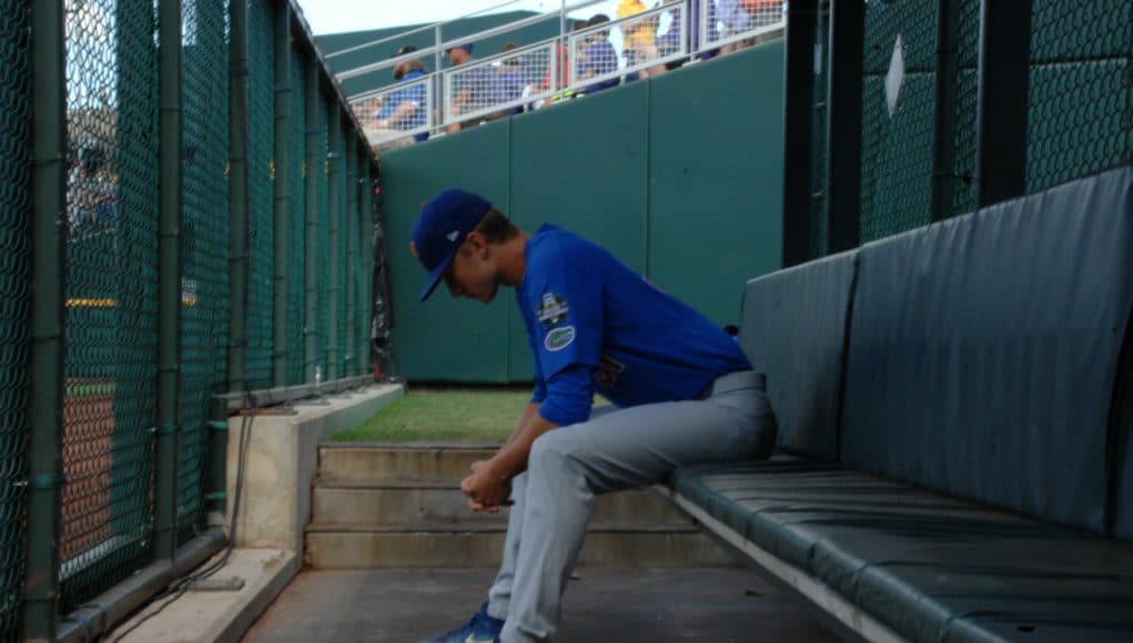 University of Florida pitcher Brady Singer sits alone in the bullpen before his start against the LSU Tigers in the College World Series- Florida Gators baseball- 1280x850