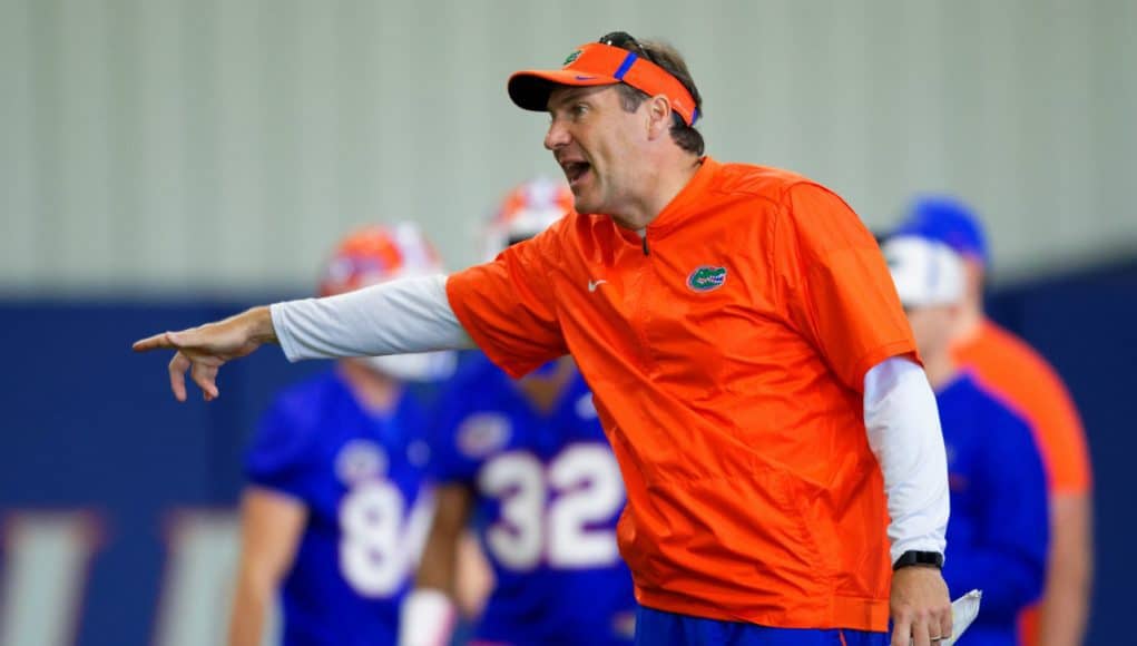 University of Florida head football coach Dan Mullen yells instructions while his football team stretches before football practice begins- Florida Gators baseball- 1280x853