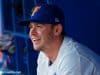 University of Florida infielder Deacon Liput sits in the dugout as the Florida Gators warm up before their season opener against Siena- Florida Gators baseball- 1280x853