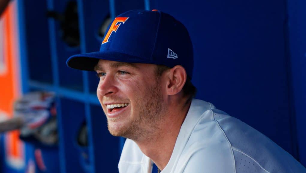 University of Florida infielder Deacon Liput sits in the dugout as the Florida Gators warm up before their season opener against Siena- Florida Gators baseball- 1280x853