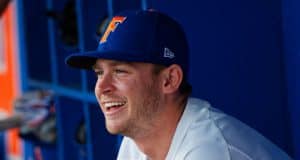 University of Florida infielder Deacon Liput sits in the dugout as the Florida Gators warm up before their season opener against Siena- Florida Gators baseball- 1280x853