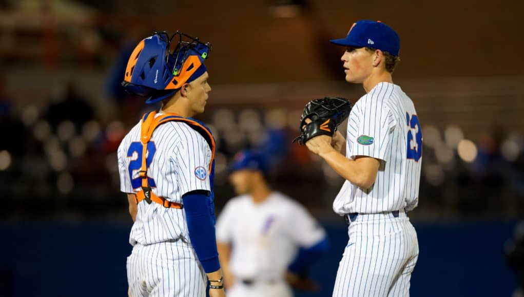 University of Florida pitcher Jack Leftwich and catcher JJ Schwarz meet at the mound in a win over the Florida State Seminoles- Florida Gators baseball- 1280x853