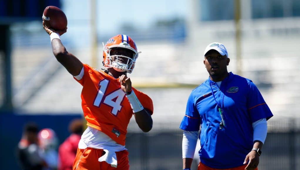 University of Florida quarterback Emory Jones throws a pass while quarterbacks coach Brian Johnson looks on- Florida Gators football- 1280x853