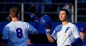 Deacon Liput congratulates University of Florida third baseman Jonathan India after a home run against Florida State- Florida Gators baseball- 1280x853