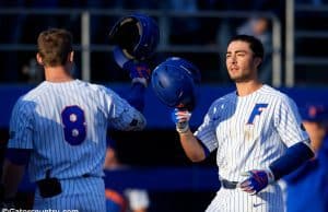 Deacon Liput congratulates University of Florida third baseman Jonathan India after a home run against Florida State- Florida Gators baseball- 1280x853