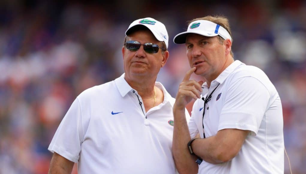 University of Florida defensive line coach Sal Sunseri confers with head coach Dan Mullen during the 2018 Orange and Blue game- Florida Gators football- 1280x853
